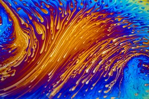 Vibrant abstract art depicting fluid swirls of blue and orange creating a dynamic visual effect.